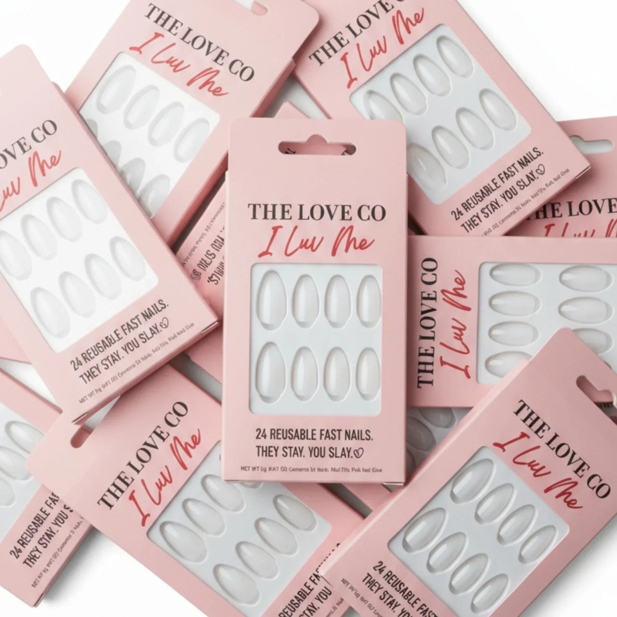 The Love Co I Luv Me pink boxes of reusable fast press-on nails arranged flat lay