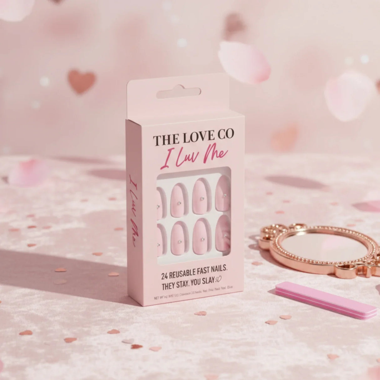 The Love Co I Luv Me pink press on nails set on soft pink background with mirror and nail file