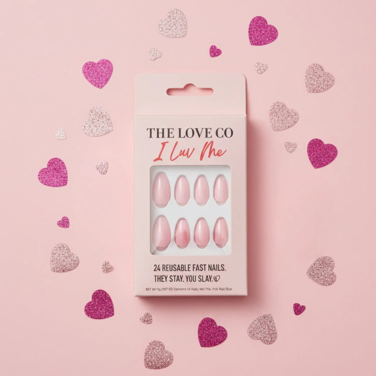 Pink press-on nails set in box with glitter hearts on pastel pink background