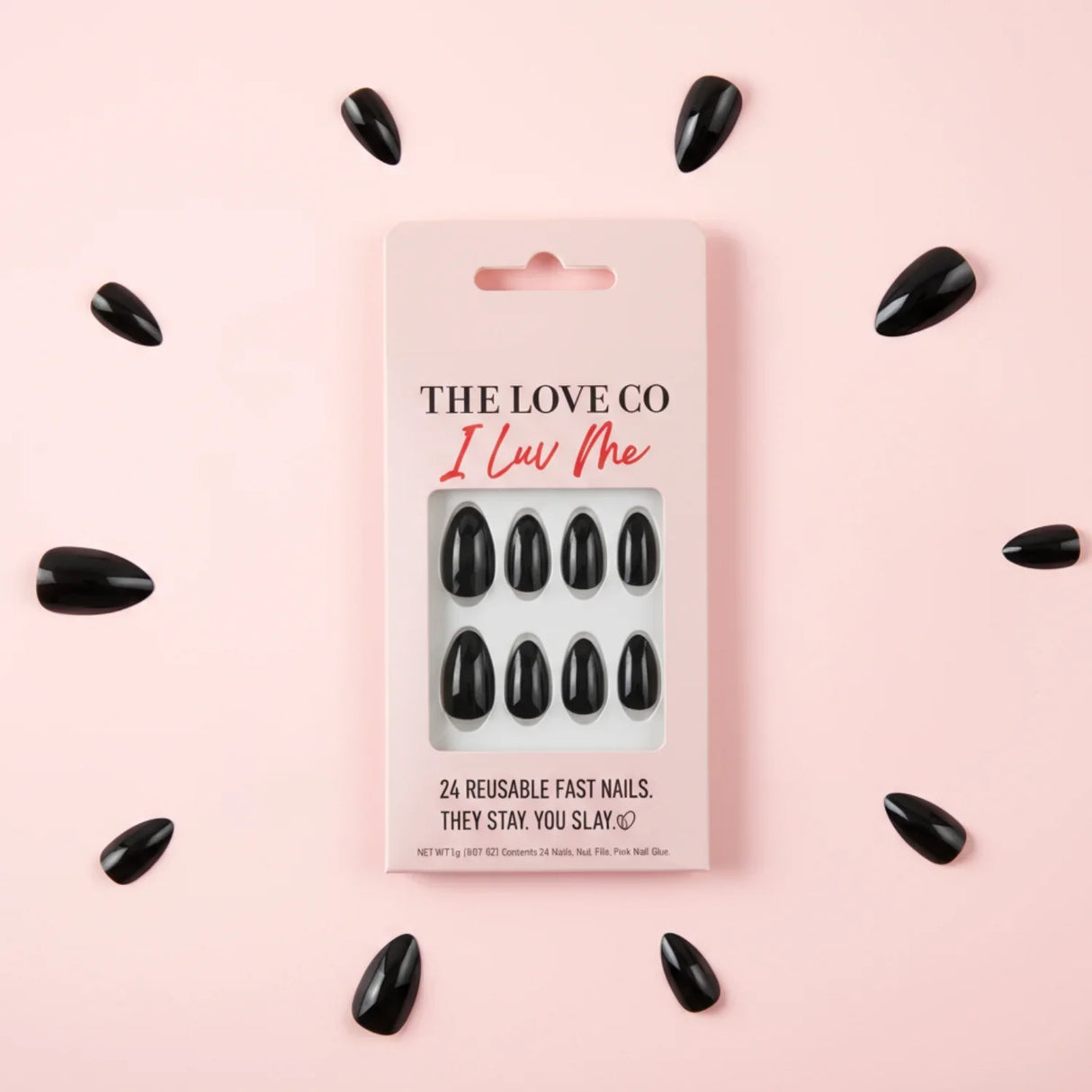 The Love Co I Luv Me black reusable press-on nails set on pink background