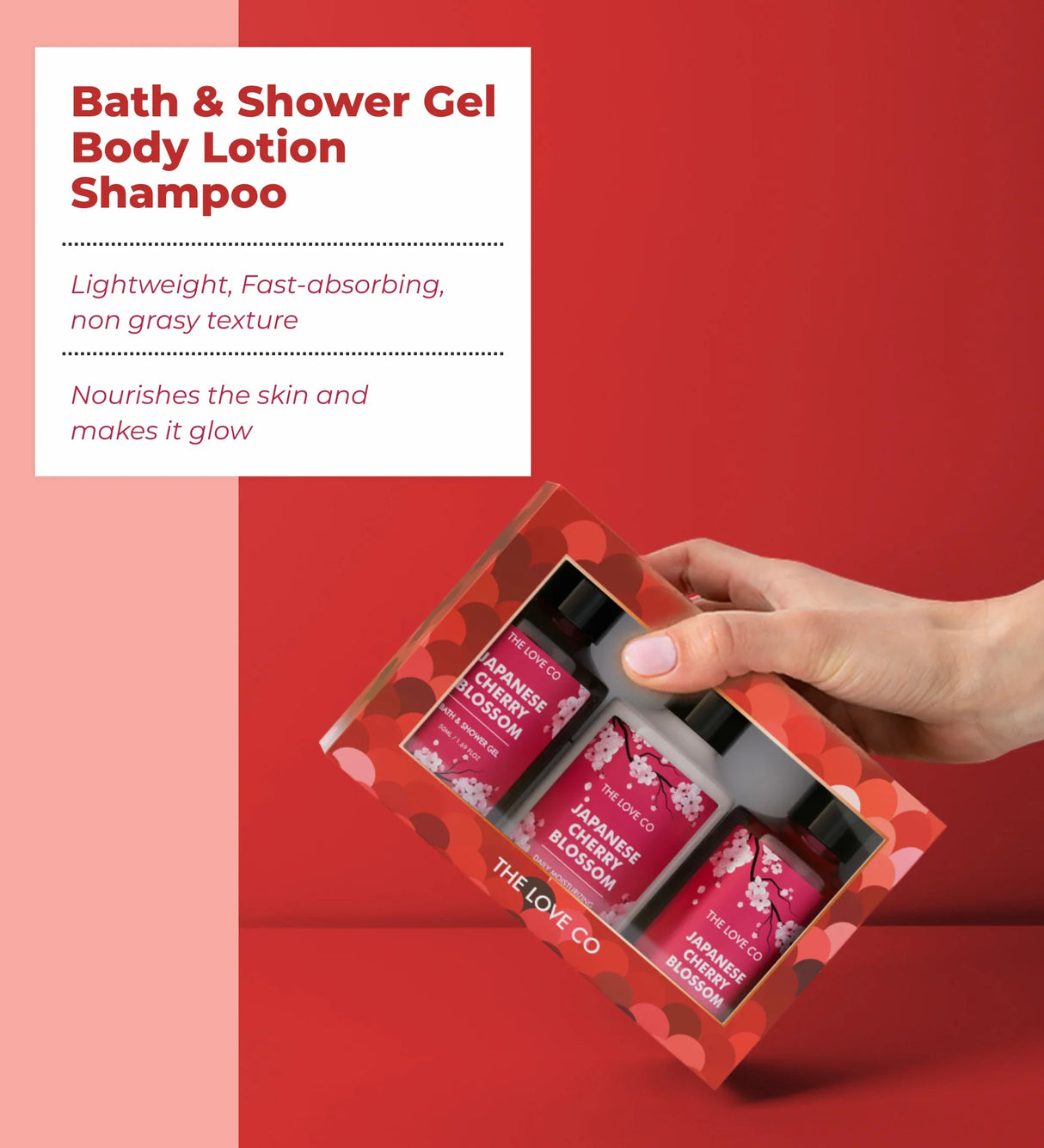 Hand holding The Love Co Japanese Cherry Blossom bath and body discovery kit gift box, red background