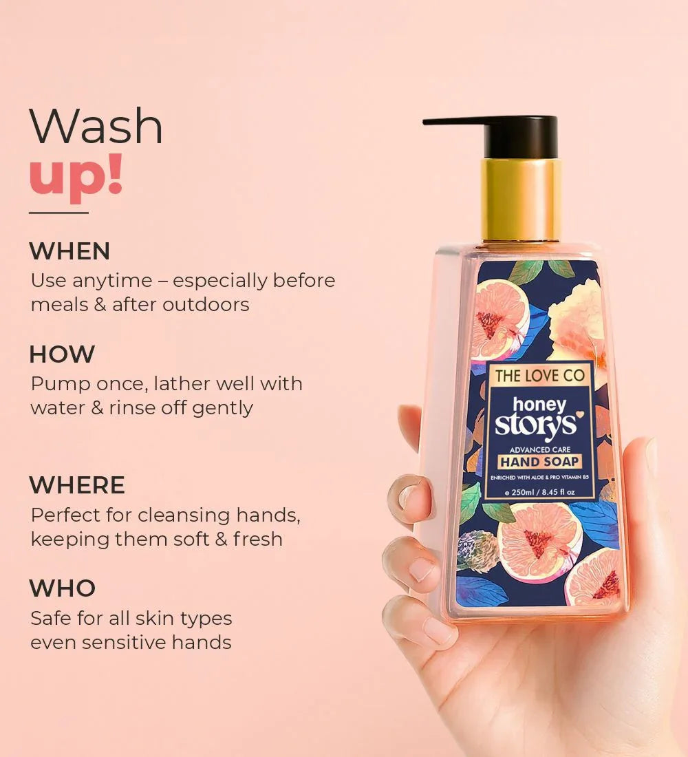 Hand holding The Love Co Honey Storys Advanced Care Hand Soap bottle with floral label on a pink background, alongside hand wash instructions.