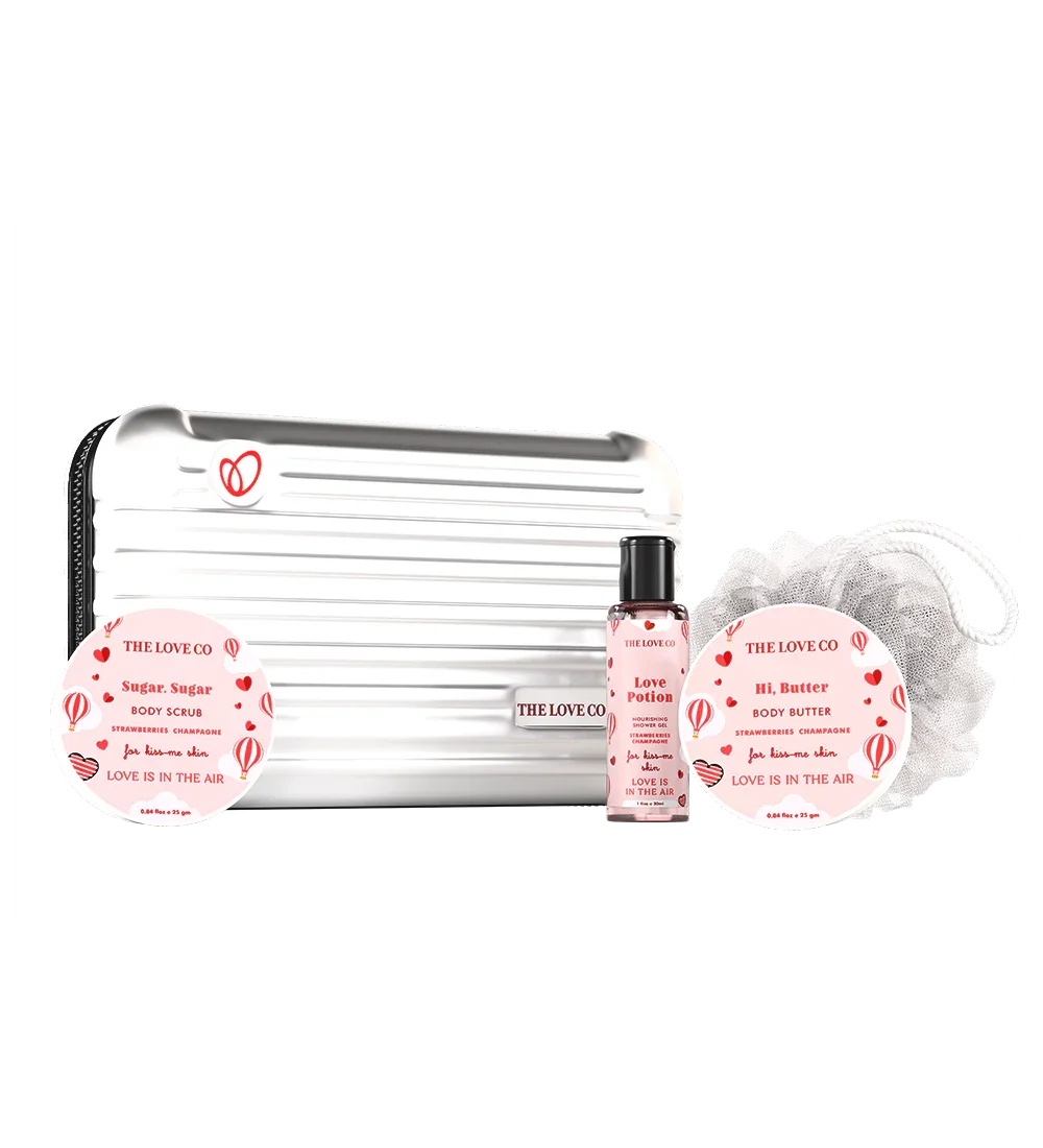 THE LOVE CO Love is in the Air Zipper Kit with body scrub, body butter, lotion, and loofah.