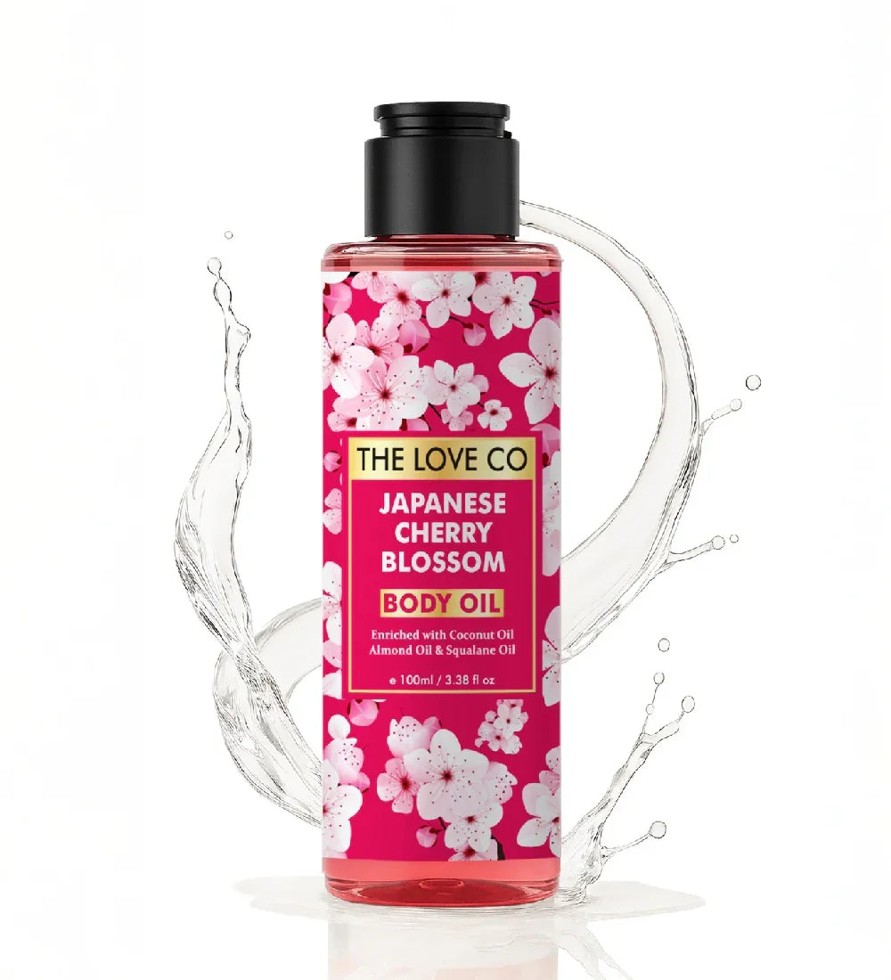 The Love Co Japanese Cherry Blossom Body Oil bottle with pink floral design and water splash
