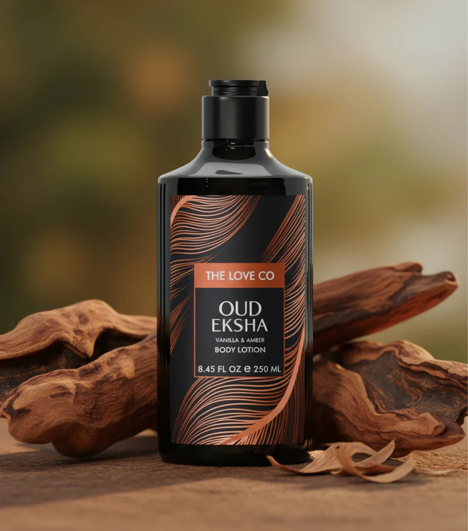The Love Co Oud Eksha vanilla and amber body lotion bottle on wood with oud bark