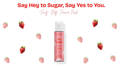 Hey Sugar fragrance body mist with strawberries, bold slogan, and fruity theme on white background.