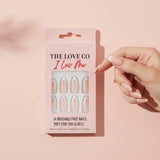 Hand with nude press-on nails holding The Love Co I Luv Me reusable fast nails box
