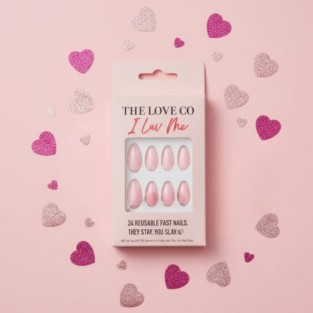 Pink press-on nails set in box with glitter hearts on pastel pink background