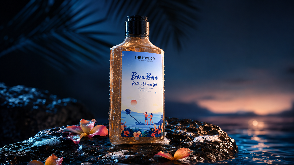 Bora Bora Body Wash bottle among tropical fruits and rose blooms in warm lagoon light