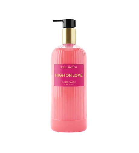 Pink HIGH ON LOVE hand wash bottle with gold pump by The Love Co on white background