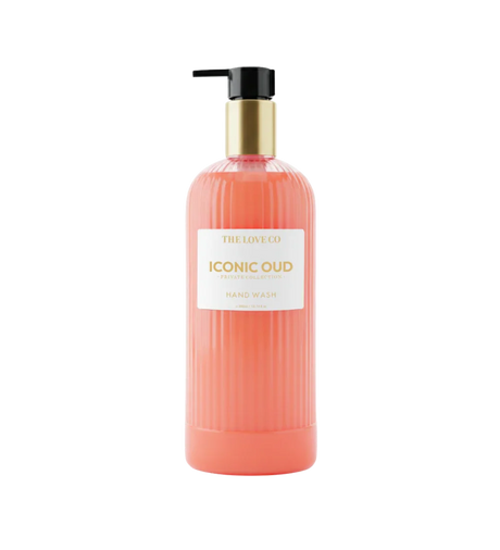 The Love Co Iconic Oud hand wash in a ribbed orange pump bottle with gold cap