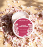 The Love Co Japanese Cherry Blossom body yogurt moisturizer surrounded by cherry blossoms