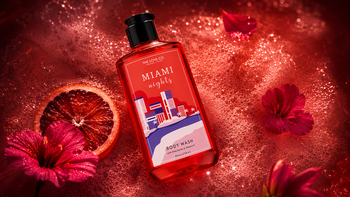 Miami Nights Body Wash bottle among peony blooms and city lights at dusk