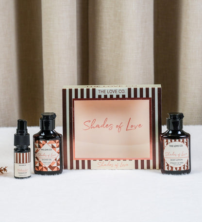 The Love Co. Shades of Love fragrance oil and body lotion set with striped packaging, displayed against a neutral backdrop