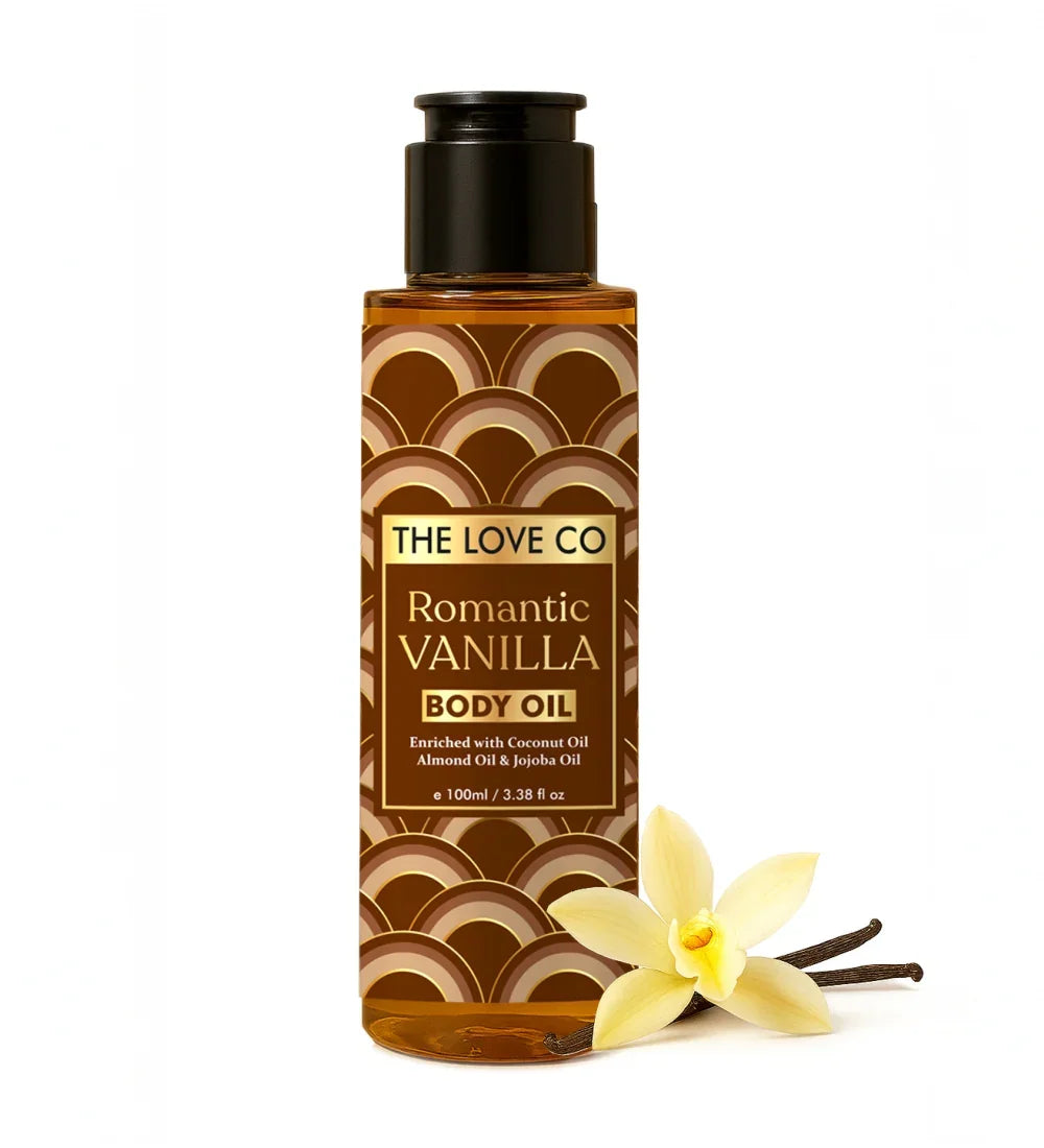 Bottle of The Love Co Romantic Vanilla body oil with a vanilla flower and vanilla bean on a white background
