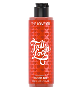 Body oil bottle with red heart pattern and 'The Love Co' branding on a white background
