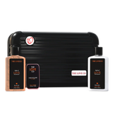 THE LOVE CO Oud of Love zipper kit with shower gel, body lotion, and solid perfume in front of a black travel case