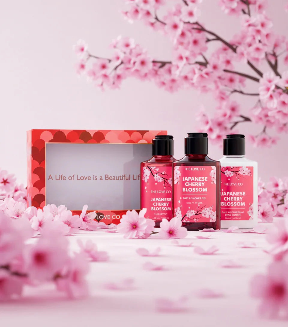 The Love Co Japanese Cherry Blossom gift set with floral bottles and pink cherry blossoms.