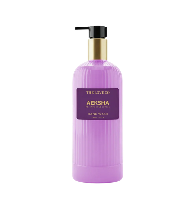 Aeksha Hand Wash by The Love Co in a purple bottle with gold pump dispenser