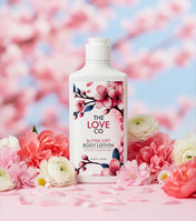 Body lotion bottle with cherry blossom design on a floral background