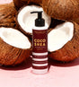 Coco Shea sunscreen lotion bottle with coconuts on a pink background