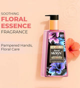 The Love Co floral essence hand soap with floral print bottle and hibiscus flower on peach background