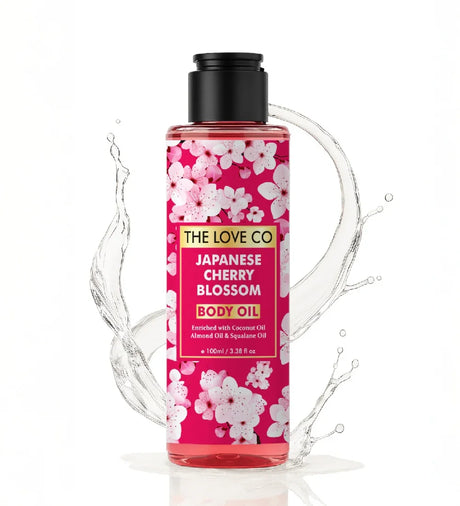 The Love Co Japanese Cherry Blossom Body Oil bottle with pink floral design and water splash