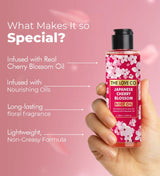 Hand holding The Love Co Japanese Cherry Blossom Body Oil bottle with pink floral design