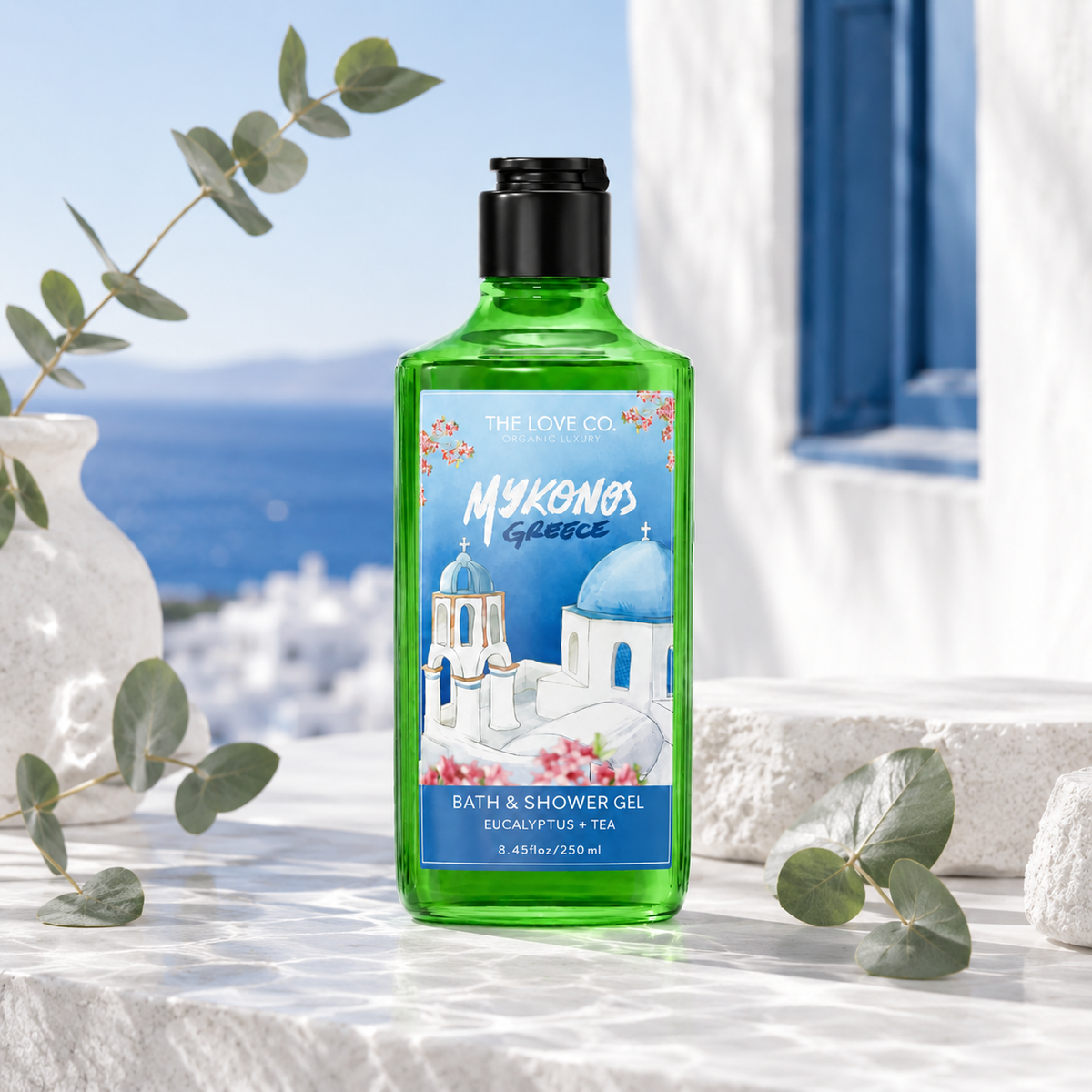 Mykonos Greece Body Wash bottle among white tea leaves and roses in Aegean light