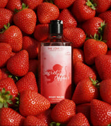 Secret Affair body wash by The Love Co. bottle on fresh strawberries