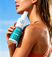 Woman holding The Love Co Bacne Warrior acne fighting body spray outdoors