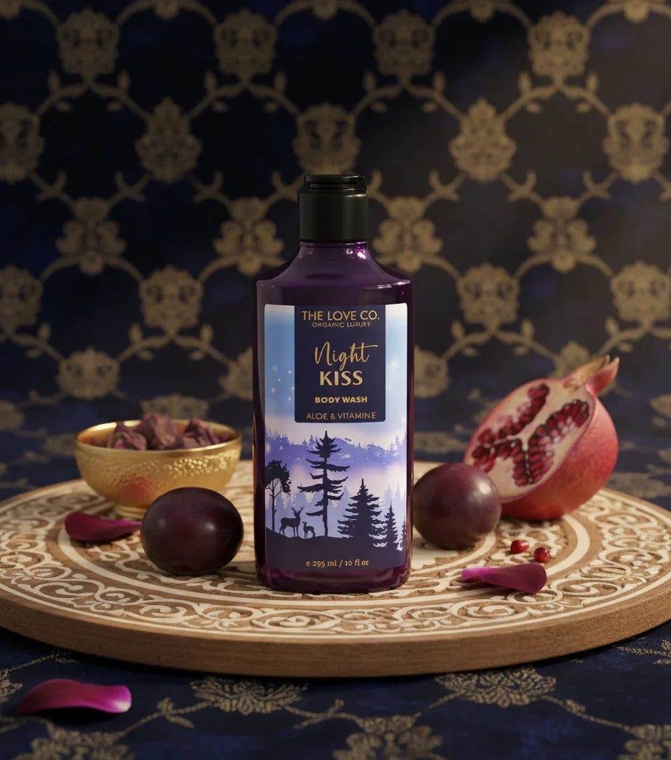 The Love Co. Night Kiss shower gel bottle with plums and pomegranate on decorative tray