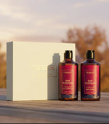 The Love Co Oud Mukhaab gift box with shower gel and body lotion on wooden surface