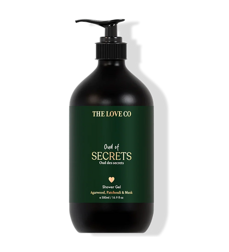 Black shower gel bottle with green label on a white background