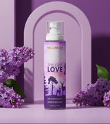 The Love Co Twilight Love body mist bottle with purple floral background and lilacs
