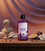 The Love Co Twilight Love shower gel bottle on wood table with passion fruit and classical bust