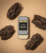 The Love Co Zeenat Al-Oud solid perfume tin with oud wood pieces on a beige background