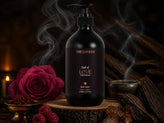 Oud of Love Body Lotion on a wooden slice with incense smoke, rose, saffron and agarwood